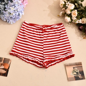 Detail view of red and white striped knit shorts with bow and ruffled edges