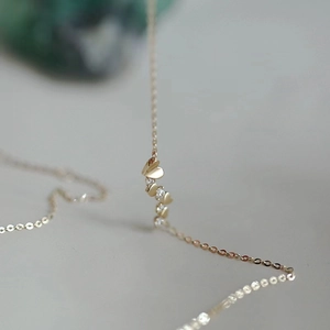 Gold heart-shaped pendant necklace with cubic zirconia stones in 14k gold plating