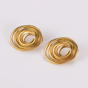 Macro detail of gold spiral earrings with glossy metallic finish and 3D textured curves