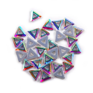 Macro shot of triangle AB crystals with flat gray back for DIY nail art and craft