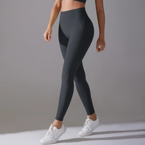 Close-up of dark grey high-waisted yoga pants showing supportive compression waistband