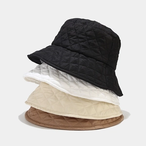 Close-up of quilted rhombic pattern bucket hats in black, white, beige, and coffee colors