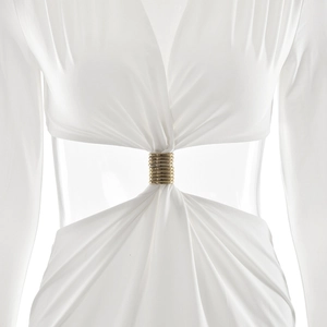 Detail of white maxi dress featuring waist cutout with elegant gold ring decoration