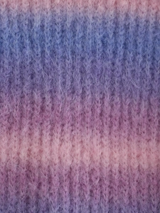 Macro shot of soft mohair knit fabric texture with pink purple and blue tie-dye gradient