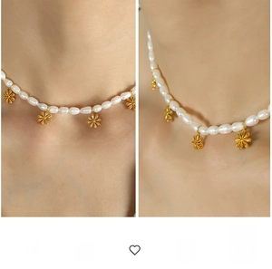 Detail of freshwater pearl necklace with gold daisy flower charms on model