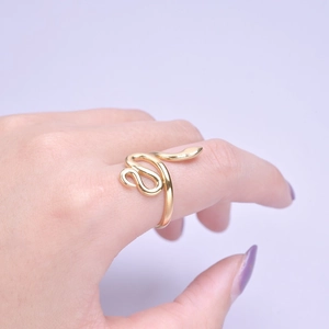 Close-up of golden adjustable snake ring showing detailed serpent design on finger