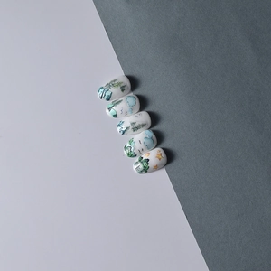 Hand-painted nature landscape press-on nails with forest and sky art on creamy white base
