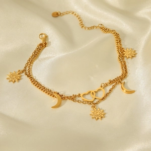 Detail of 18K gold stainless steel double-layered anklet with sun moon and heart charms