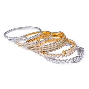 Macro shot of gold and silver multi-layer wrap bracelets with pave white zircon stones