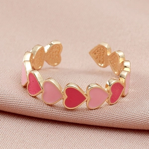 Anello d'oro regolabile con cuori in smalto rosa su sfondo di seta