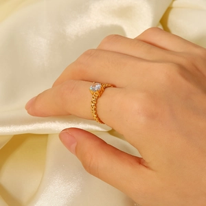 Detail of 18K gold-plated woven wheat pattern ring with sparkling zircon on hand
