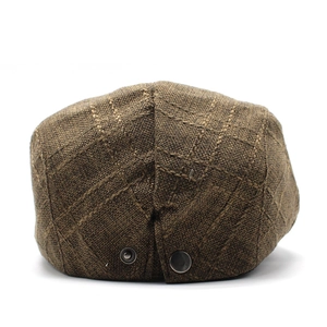 Rear view of brown checkered ivy cap showing metal buckle detail and linen texture