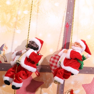Detail of electric climbing Santa Claus figures on gold bead ropes with warm festive lighting