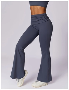 Detail of high-waist slate blue flared yoga pants with ruched waistband and wide leg cut