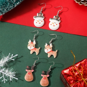 Three pairs of glittery Christmas earrings featuring snowman and reindeer designs