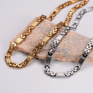 Hip hop style stainless steel braided necklaces in gold and silver finish shown on stone