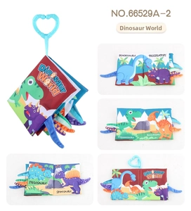 Macro detail of dinosaur baby cloth book showing 3D tails and colorful sensory illustrations