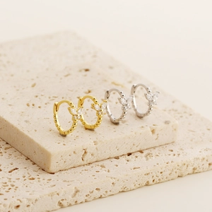Detail of vintage S925 silver butterfly huggie earrings with sparkling crystals