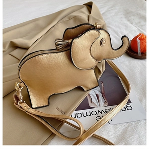 Detail of creative golden elephant shaped crossbody bag with lychee grain texture