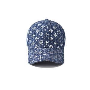 Close-up of deep blue tweed baseball cap with reflective silver floral sequins