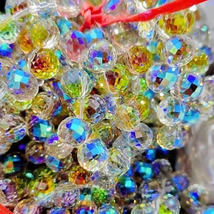 Macro shot of 8mm multifaceted strawberry crystal glass beads with iridescent finish coating