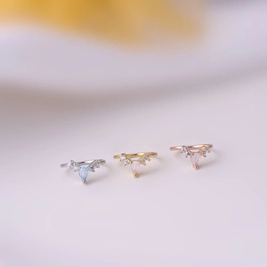 Three-piece V-shaped nose rings in silver, gold, and rose gold with teardrop opal stone