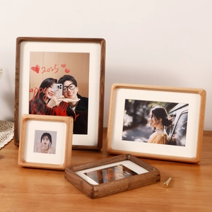Black walnut and natural solid wood photo frames with rounded corners and white mats