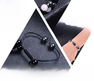 Detail of adjustable double-layer rose quartz and obsidian beaded bracelet on wrist