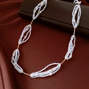 Elegant beaded pearl necklace with golden twisted metal bars in a vintage layered design