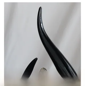 Close-up of modern black ceramic sculpture showing sleek curved lines and glossy finish