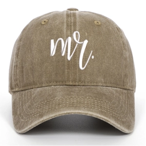Close-up of white mr. embroidery on a vintage washed khaki cotton baseball cap