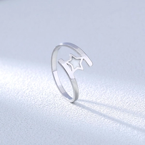 Macro side view of silver star shaped open ring with polished finish and hollow geometry