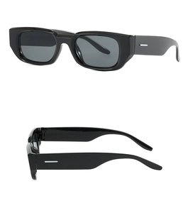 Detail view of vintage narrow rectangular sunglasses with thick glossy black frames