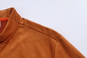 Detail of camel suede jacket showing the collar, refined texture and shoulder seams