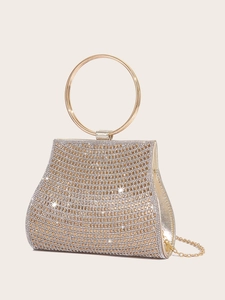 Macro detail of champagne gold evening bag showing sparkling rhinestones and metal handle