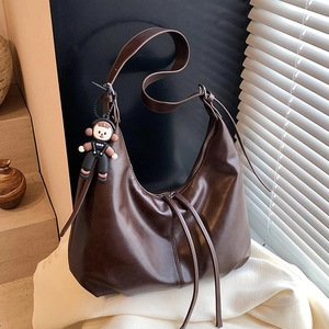 Retro brown large capacity shoulder bag for women with cute astronaut pendant charm