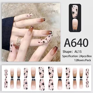 Macro detail of almond nails with brown gradient and minimalist cow print patterns