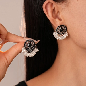 Vintage bohemian style earrings with black gemstone and white faux pearl tassels