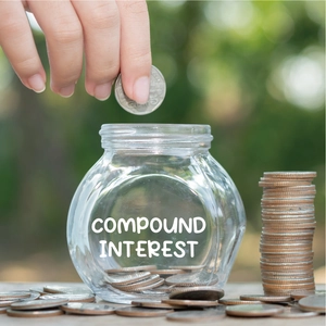 Macro view of a glass jar filled with coins for compound interest savings concept
