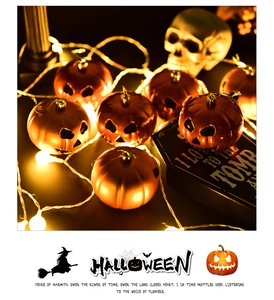 Detail of warm glowing orange pumpkin LED string lights for Halloween party decor