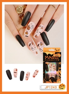 Detail of Halloween press on nails with pumpkin and ghost motifs in premium packaging