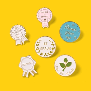 Set of 6 colorful enamel pins with inspirational quotes on a bright yellow background