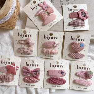 Pink fabric hair clips set featuring bunnies and stars on spotted cards for girls