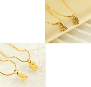 Detail of crystal letter A and B pendants on a gold snake chain made of stainless steel