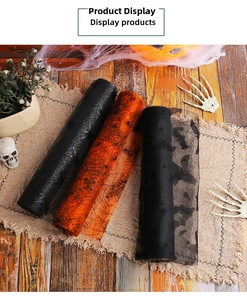Detail of Halloween mesh rolls featuring spider webs and bats on a rustic table display