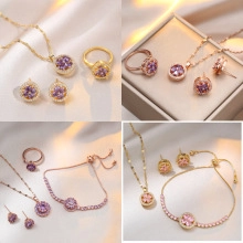 Macro detail of rose gold jewelry set featuring purple and pink zircons and small diamonds