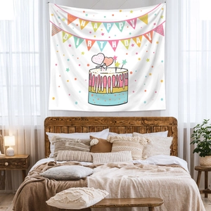 Close-up of bohemian Happy Birthday tapestry hanging above a bed for room decoration