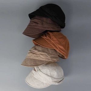 Vertical stack of five breathable linen newsboy caps in black brown and khaki tones