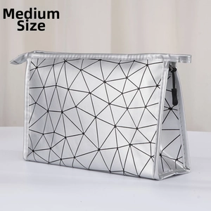 Detail view of medium silver geometric folding makeup bag with metallic finish and zipper