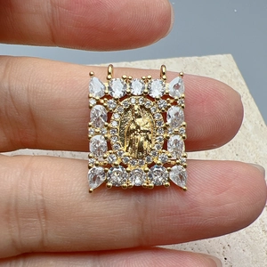 Gold Virgin Mary pendant necklace with sparkling cubic zirconia crystals and oval relief